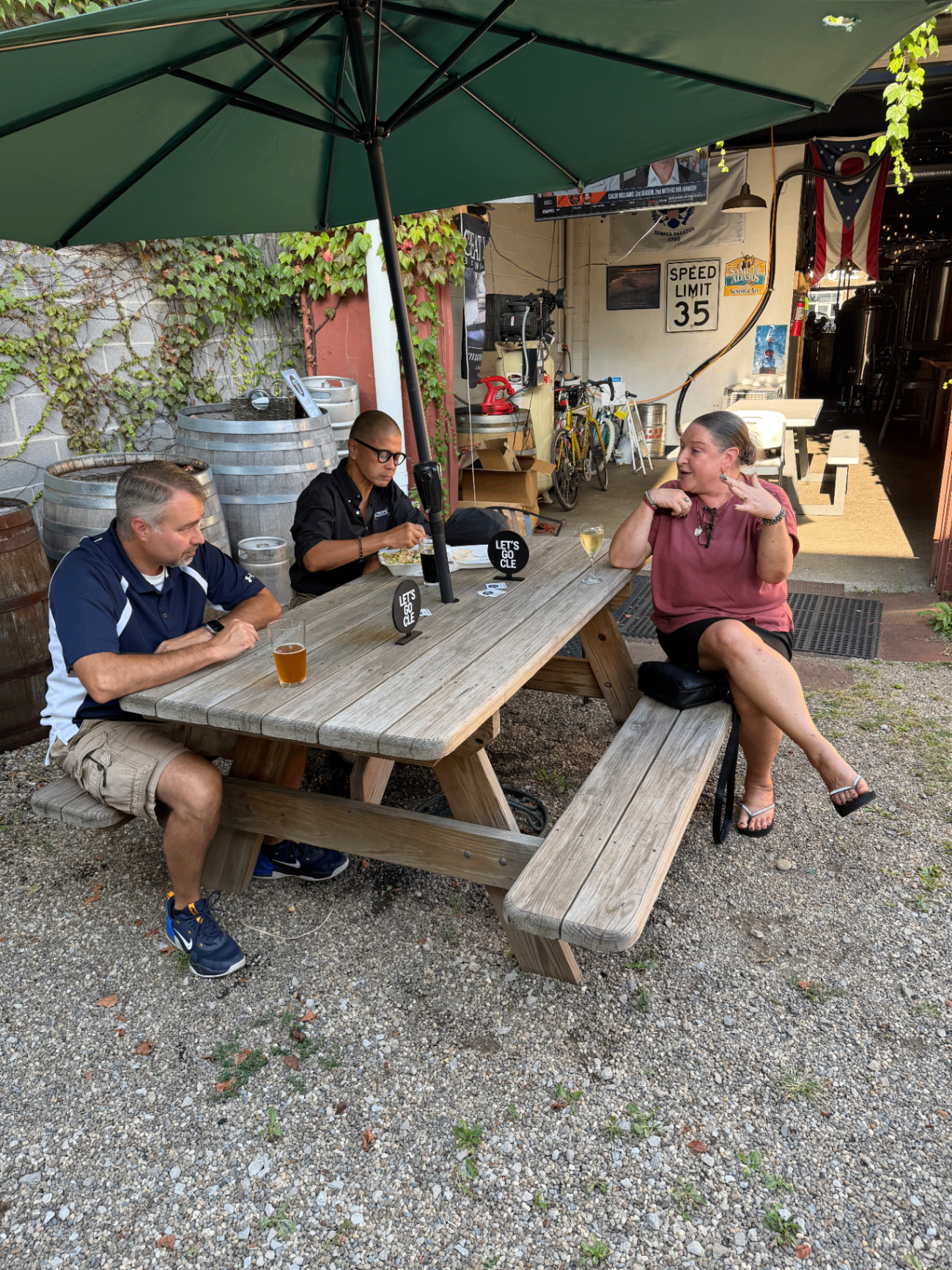 Side Door attendees under the umbrella at the brewery patio