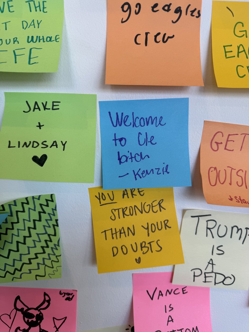 Stick Together CLE sticky note wall detail: Kids, adults, everybody.