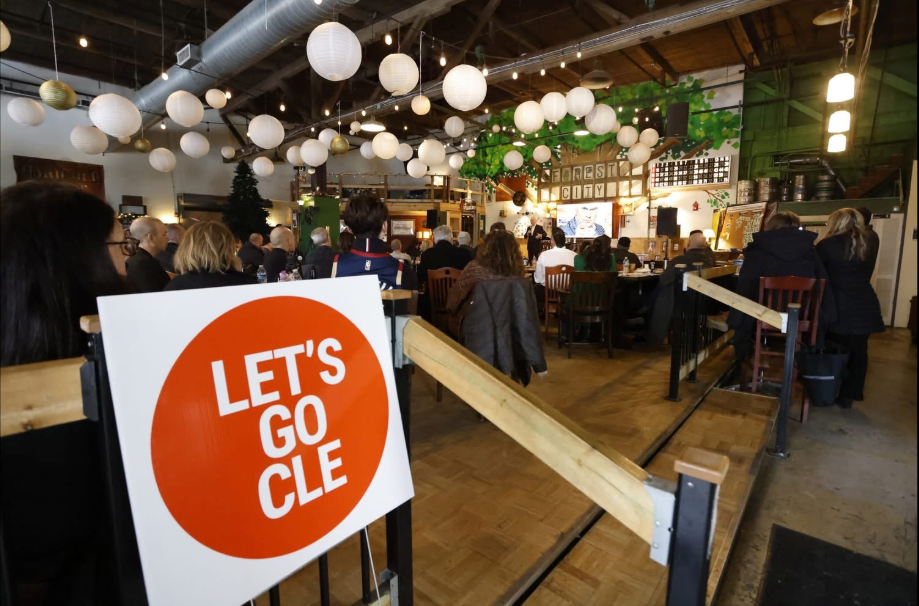 Attendees facing the stage at a LET’S GO CLE event inside Forest City Brewing