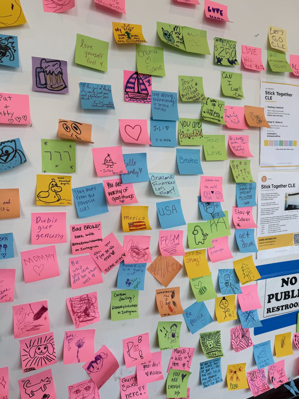 Stick Together CLE sticky note wall detail: One note, one person.